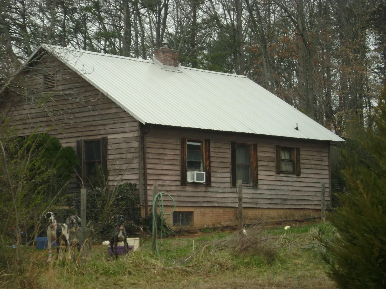 White metal roof on an old wood sided farmhouse, from a Asphalt Shingle Roof Repair job in Lee Center